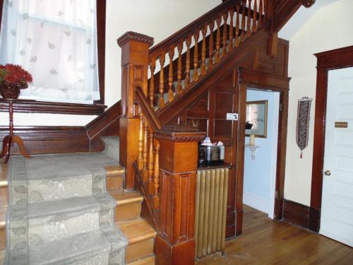 a wooden staircase in a home with a window at Rideau Inn in Ottawa