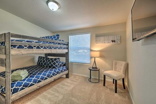 a bedroom with two bunk beds and a chair at Bright and Modern Flagstaff Cottage Escape! in Mountainaire