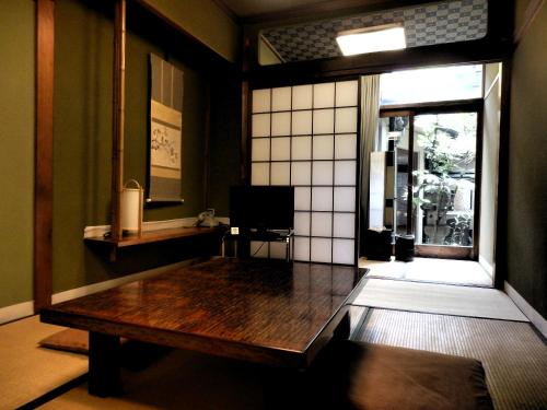 a room with a wooden table in a room with a window at Murataya in Kanazawa