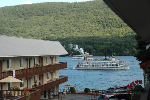 a large boat on the water next to some buildings at Park Lane Motel in Lake George