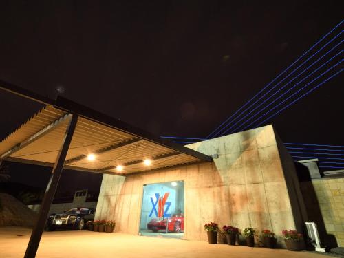 a building with a painting on the side of it at night at XYZ speciale in Shirahama