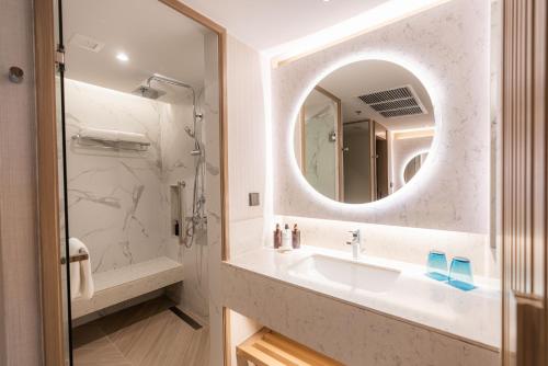 a bathroom with a sink and a mirror at Holiday Inn Resort Phuket, an IHG Hotel - SHA Extra Plus in Patong Beach