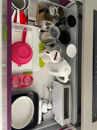 a refrigerator filled with lots of kitchen utensils at Buenavista Apartment in Sitges