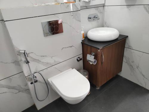 a bathroom with a toilet and a sink at Hotel Guru Surbhi in Pāonta Sāhib