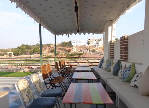 a row of tables and chairs on a patio at Lakeside Inn Ratanada in Jodhpur
