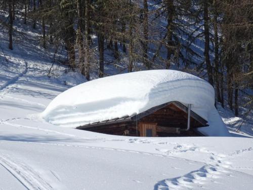 a pile of snow on top of a building at Haus Egger in Kartitsch