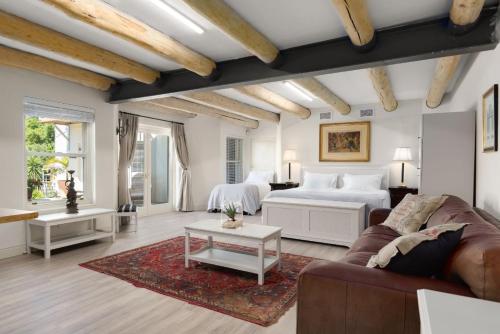 a living room with a bed and a couch at 4 Piet Retief in Stellenbosch