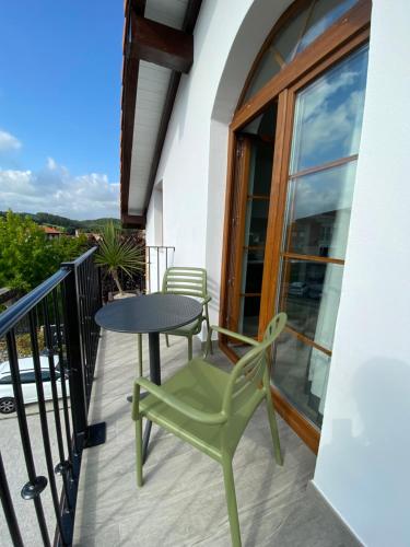 a patio with a table and chairs on a balcony at Jardines Villaverde in Villaverde de Pontones