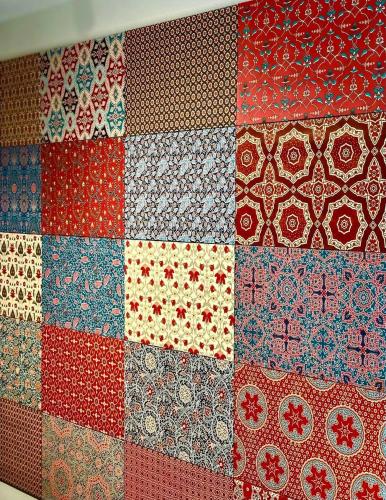 a quilt with many different colors and patterns on it at Andor Hotel in Yerevan