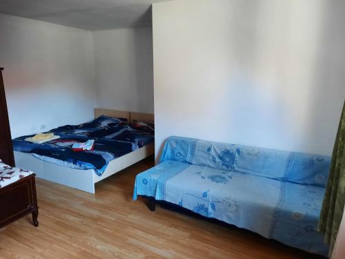 a bedroom with two beds and a couch at Casa Adrian CAMERE CENTRU VECHI in Braşov