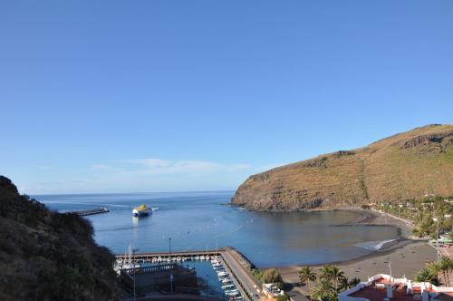 a boat is docked in a body of water at Vivienda Vacacional Villa El Mirador in San Sebastián de la Gomera