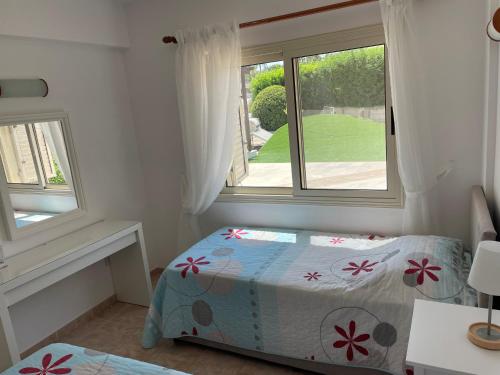 a small bedroom with a bed and a window at Ilios Akti in Lachi