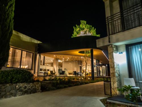 a house lit up at night with lights at Kfar Giladi Hotel in Kefar Gil‘adi