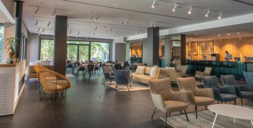 a restaurant with chairs and tables and a bar at Kfar Giladi Hotel in Kefar Gil‘adi