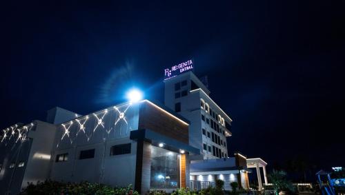 a building with a sign on top of it at night at Regenta Central Somnath, Bhalpara in Somnath