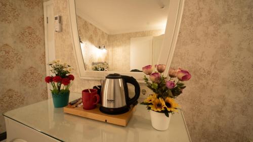 
a bathroom with a vase of flowers on the counter at Old City Viva Hotel in Istanbul
