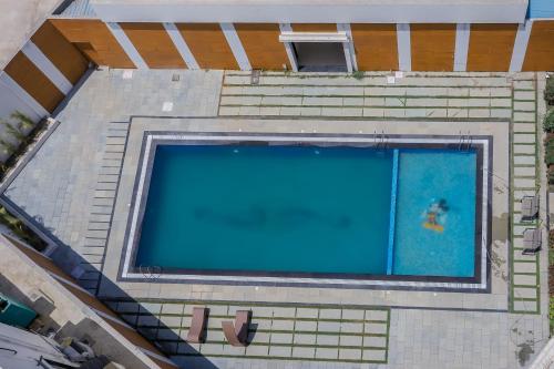 an overhead view of a swimming pool on a building at Regenta Central Somnath, Bhalpara in Somnath