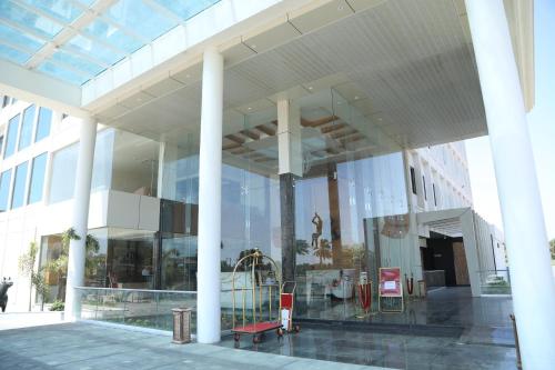 a large glass building with a playground inside of it at Regenta Central Somnath, Bhalpara in Somnath