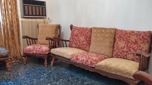 a couch and two chairs in a room at Entire House with garage, yard at Amfiali close to Piraeus Port in Piraeus