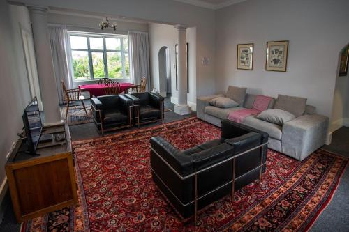 a living room with a couch and a table at Harcourt Lodge in Durban