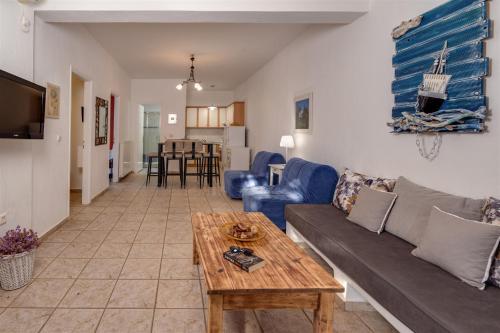a living room with a couch and a table at Anemousa Studios in Otzias