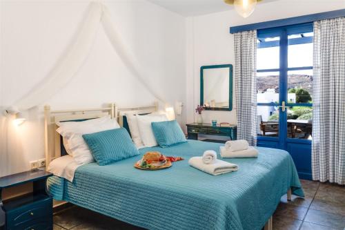 a bedroom with a bed with towels on it at Anemousa Studios in Otzias