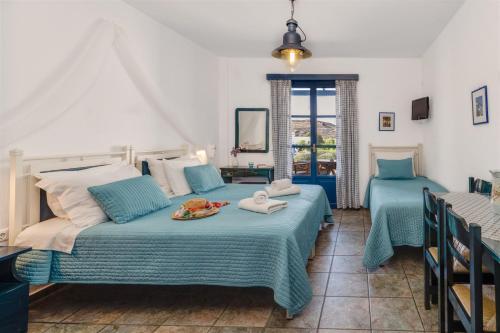 a bedroom with two beds with a plate of food on it at Anemousa Studios in Otzias