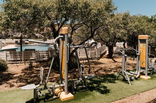 a park with a bunch of exercise equipment at Anemousa Studios in Otzias