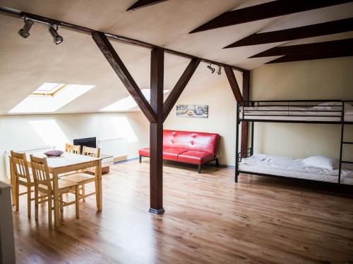 a room with bunk beds and a table and a dining room at Amber in Liepāja