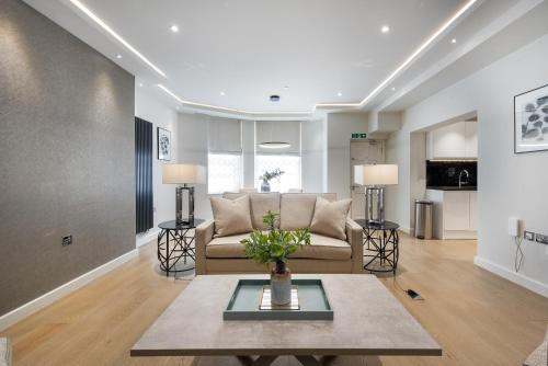 a living room filled with furniture and a large window at Kensington Court by CAPITAL in London