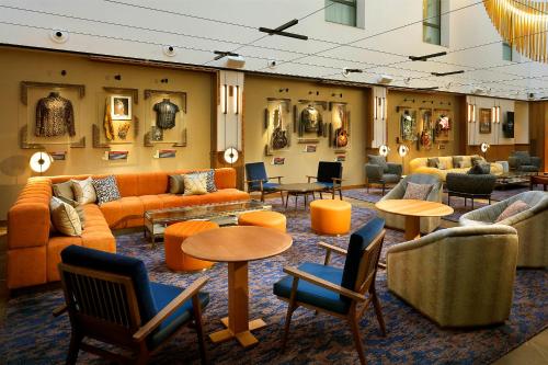 a large room with couches and tables and chairs at Hard Rock Hotel Madrid in Madrid