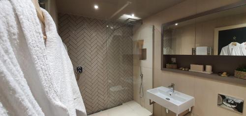 a bathroom with a sink and a shower with a shower curtain at Luxury One Bedroom Apartment Within the City Walls in York