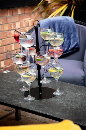 a group of wine glasses sitting on a table at The Eccleston Hotel; BW Signature Collection in Saint Helens
