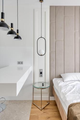 a bedroom with a glass table next to a bed at BASIS APARTMENTS - Adults Only in Kyiv