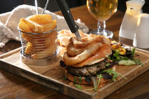 a plate of food with a hamburger and onion rings at The Eccleston Hotel; BW Signature Collection in Saint Helens