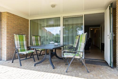 a table and chairs sitting on a patio at Escape, appartement met groot terras in Buren