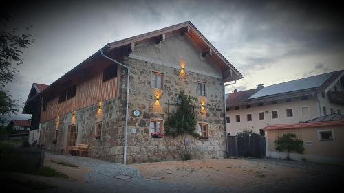 a stone house with lights on the side of it at Landhof Schuhbeck in Kay