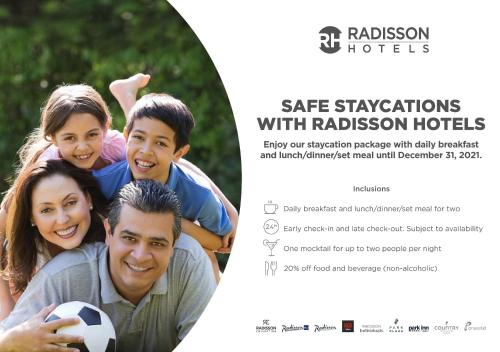 a poster of a family with a soccer ball at Park Inn Gurgaon in Gurgaon