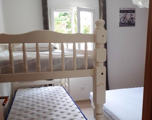 a white bunk bed in a room with a window at Villa de 2 chambres avec piscine privee jardin clos et wifi a Colonzelle in Colonzelle