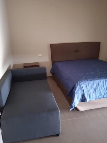 a bedroom with a large bed with a blue bed frame at Le Zagare b&b in Paola