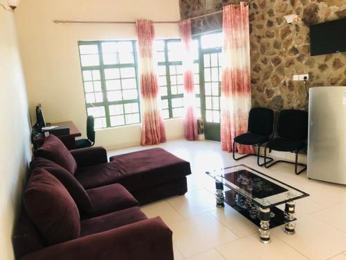 a living room with a couch and a table at The Lake House - Lake Baringo in Ol Kokwe