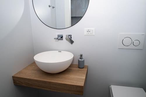 a bathroom with a white sink and a mirror at Marconi 442 in Sanremo