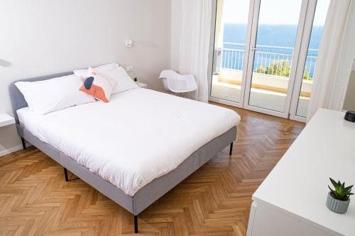 a bedroom with a bed and a large window at Marconi 442 in Sanremo