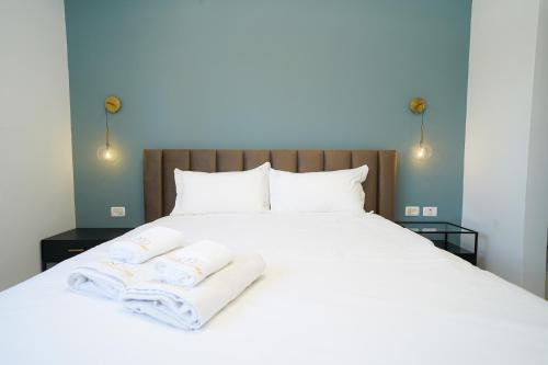 1 cama blanca grande con 2 toallas en Maorissimo tower, en Acre