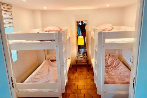 a room with three bunk beds in a room at Fin lägenhet i vårt hus med uteplats på Käringön in Käringön