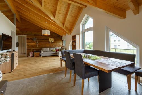 a kitchen and dining room with a wooden ceiling at Ferienwohnung Schreierhof Bio Bauernhof in Feldkirchen in Kärnten