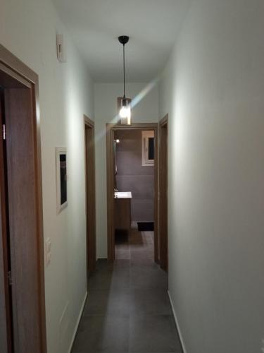 a hallway with a hallway leading to a bathroom at Seaside luxury apartment in Analipsi