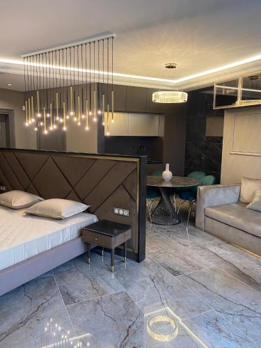 a bedroom with a bed and a living room at Apart Elena Arcadia Sea View in Odesa