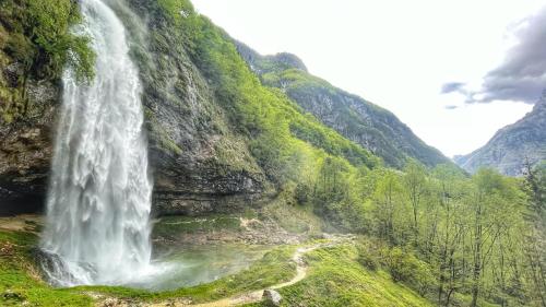 a waterfall on the side of a mountain at STARLING Apartment Nassfeld in Hermagor