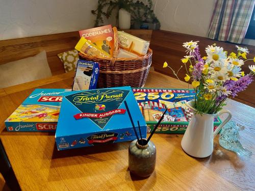 a table with some snacks and a vase with flowers at STARLING Apartment Nassfeld in Hermagor